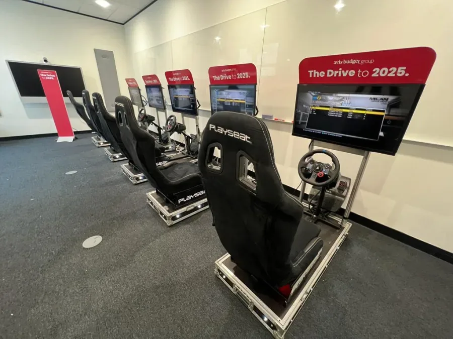Row of racing simulators with bespoke branded headers for a corporate roadshow
