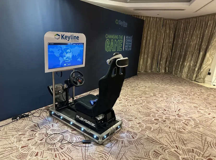 Driving simulator with a branded screen surround at a conference