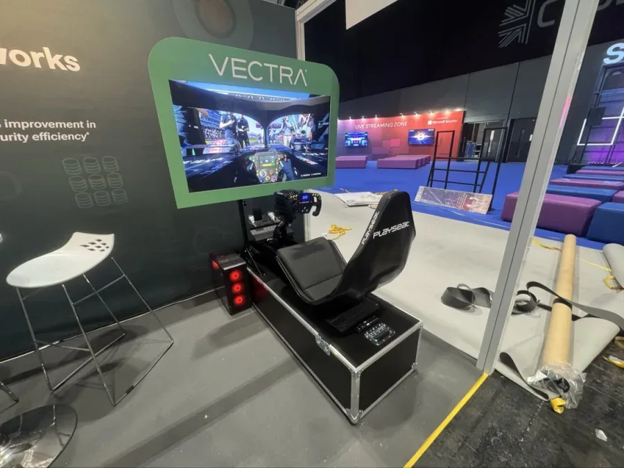 Branded F1 simulator with a screen surround on a trade show stand