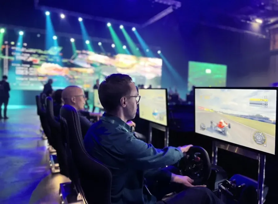 Guest racing an F1-style car on a racing simulator at a live event